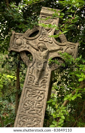 Celtic style cross with Jesus on the front.  Taken in English graveyard.