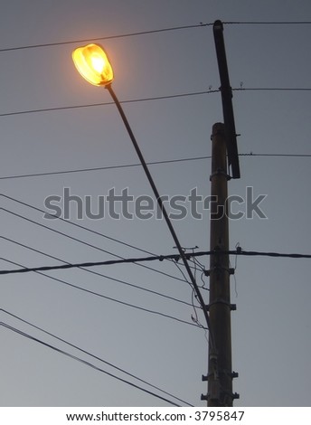 Public illumination pole, with electricity wires and cables