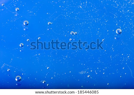 Abstract blue background from the liquid with air bubbles closeup