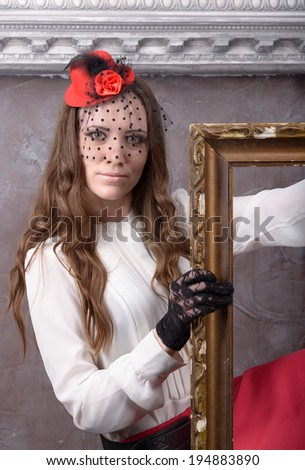 Portrait of a girl with an empty picture frame