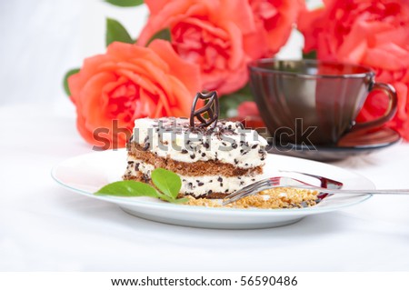 Sweet chocolate dessert with nuts, rose and cup of coffee