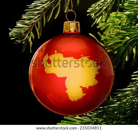A red bauble with the golden shape of  Venezuela hanging on a christmas tree isolated on black.(series)