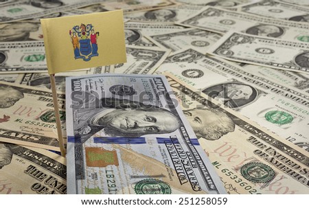 Flag of New Jersey sticking in a variety of american banknotes.(series)