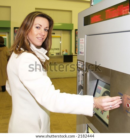 Ticket machine at the station with a woman customer