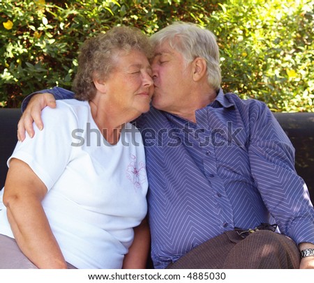 stock photo Couple of old swingers having a cuddle