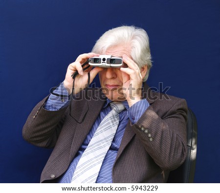 Senior executive searching for another job with binoculars