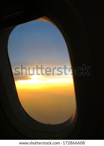 Airplane window on sunset