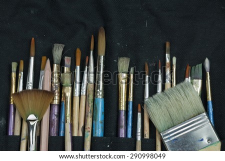 Artist paint brushes in thier pouch read for use
