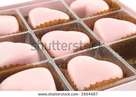 Pink love heart chocolates on a white background