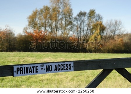Gate in front of field with a sign Private No Access