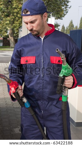 Gas Station Worker Refilling Car at Service Station