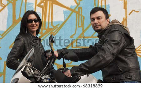 stock photo A Couple of Motorcycle Riders with their Custom Bike