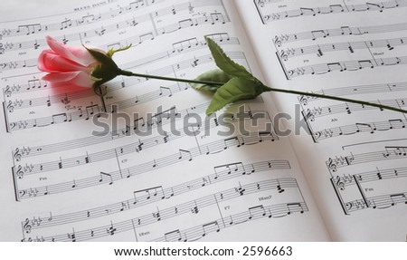 sheet of music and rose