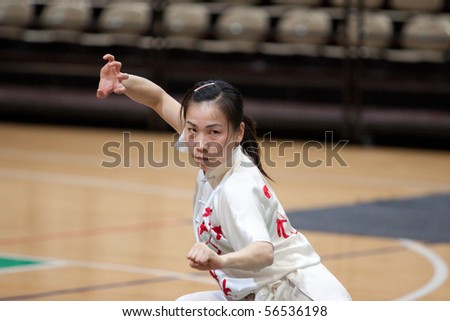 MODENA, ITALY - FEBRUARY 02: Students form Beijing sports university, perform Wushu Kung Fu routines during the show in Modena, Italy on february 2, 2010 at Palapanini building.
