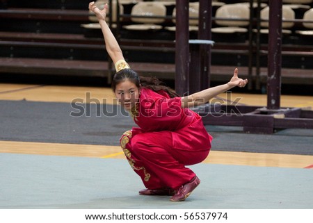 MODENA, ITALY - FEBRUARY 02: Ma Lingjuan, student from Beijing sports university, perform wushu bare hand routines during the show in Modena, Italy on february 2 2010 at Palapanini building.