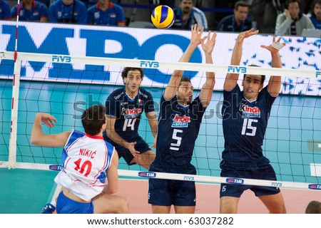 volleyball player spiking ball. Milos Nikic spikes ball at