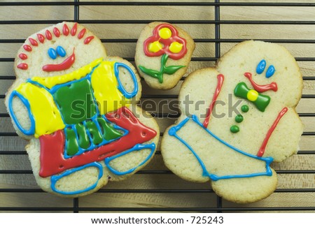 A happy couple made of sugar cookies, cooling on a baking rack.