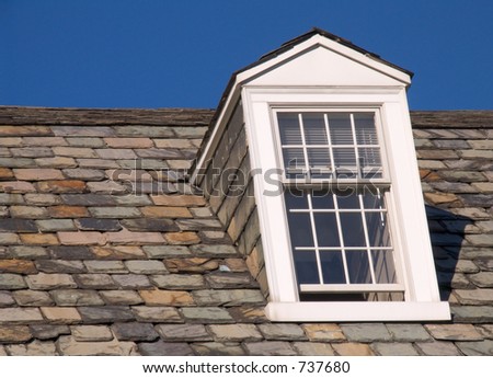 Dormer window on the right, with slate roof tiles.