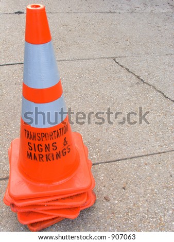 Orange safety cone with text.