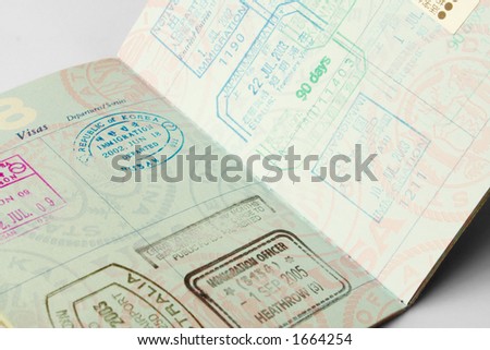 Closeup of an American passport with stamps from a variety of countries within the past couple of years, including England, Australia, Japan, and the Republic of Korea.