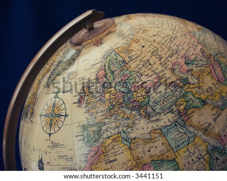 Classic globe with compass showing the western hemisphere.