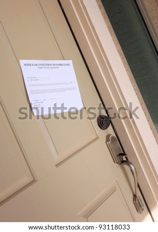Notice of foreclosure hanging on the front door of a family home.