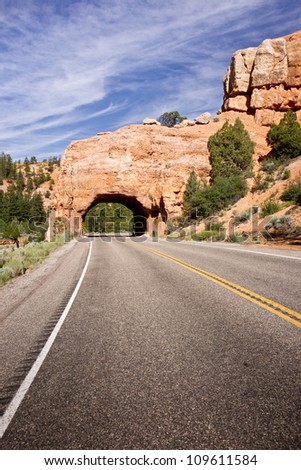 A sandstone tunnel marks the entry to Bryce Canyon National Park region in Utah\'s Red Canyon.