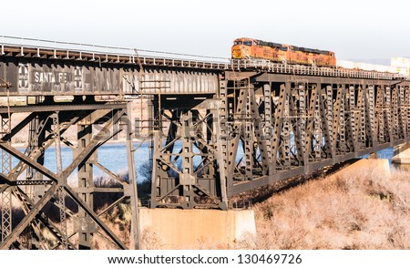 RURAL ARIZONA - FEBRUARY 7: A freight train crosses the trestle over the Colorado River at the Arizona-California border heading west with a full load of containers on February 7, 2013..