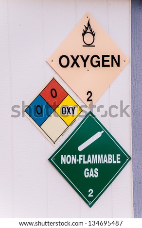 Warning signs alert workers to the presence of oxidizing chemicals in the workplace.