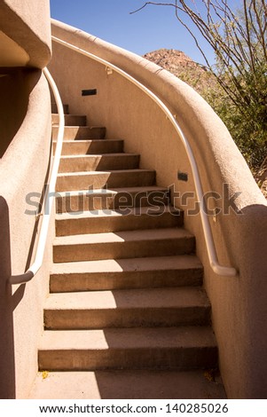 A curvilinear stairway in a stucco building in the Arizona desert