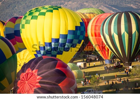 RENO - SEPTEMBER 7: Hot air balloon teams rush to inflate their balloons to start the 38th annual Great Reno Balloon Race in Reno, Nevada on Sept. 7, 2013