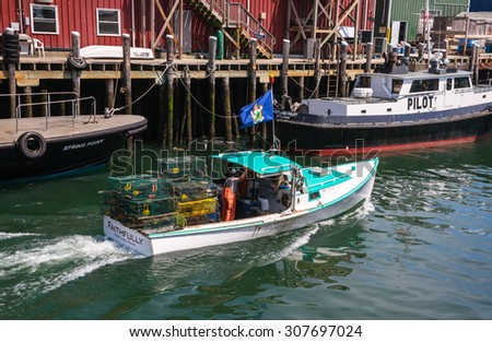 PORTLAND, ME, USA, AUGUST 10, 2015: At day\'s end a lobster fishing boat heads home after delivering its catch to market.