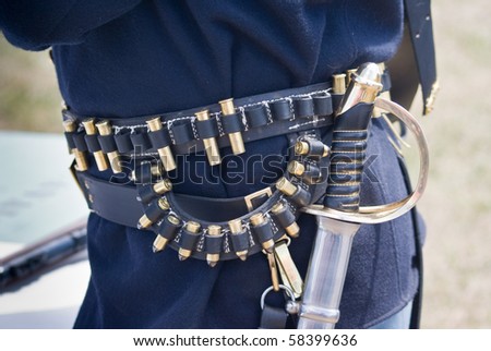 A US Cavalry soldier displays a sword and ammunition belt as part of his period uniform at reenactment of Custer\'s Last Stand