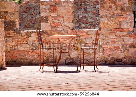 Table and chairs on a romantic stone balcony
