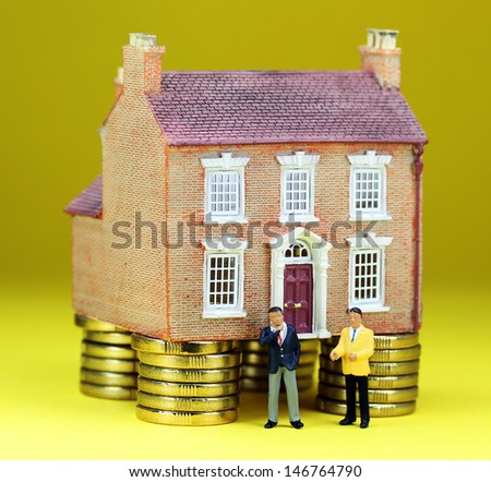 A real estate agent and a prospective buyer in front of a house on gold coin stilts, with the prospective buyer about to walk away, suggesting you can\'t win them all!