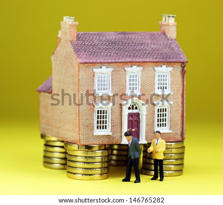A real estate agent and a prospective buyer in front of a house on gold coin stilts, with the prospective buyer about to walk away, suggesting you can't win them all!