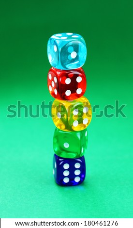 Five translucent dice stacked end to end producing a colored stack, with different number all white showing.