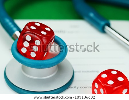 A Doctors aqua colored stethoscope with a red dice resting on the top of it, both resting on a doctors sick certificate pad, asking the question do you gamble with your health.