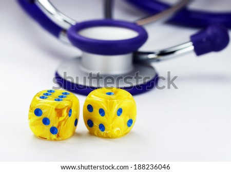 Two yellow marbled yellow dice with blue dots for numbers in front of a purple stethoscope, asking the question do you gamble with your health?