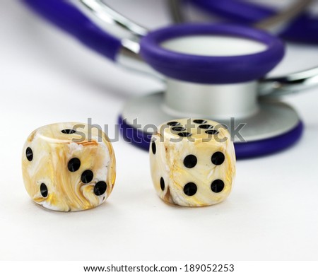 A Doctors purple stethoscope with two ivory marbled dice with black spots placed next to it, asking the question, do you gamble with your health.
