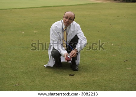 Medical doctor on the golf course checking a cricket ball with his stethoscope