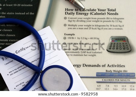 Doctors’ desk showing stethoscope, pen,  sick note pad and daily energy chart.