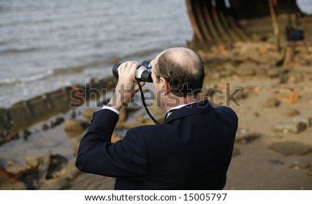 Businessman in the rusting hull of shipwreck, with binoculars looking out to the horizon, asking the question is their an escape from a sinking business