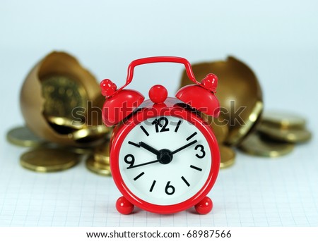 A red alarm clock with a cracked golden investment egg cracked open revealing the Golden contents of coins in front it, signifying the longevity of the investment.