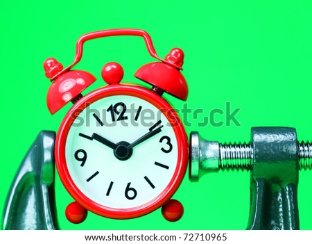 A red alarm clock placed in a Grey clamp against a pastel green background, asking the question do you manage your time effectively?
