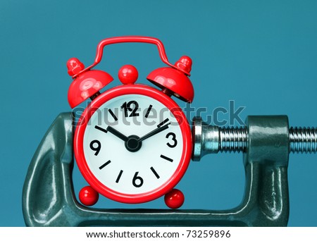 A red alarm clock placed in a Grey clamp against a pastel blue background, asking the question do you manage your time effectively?