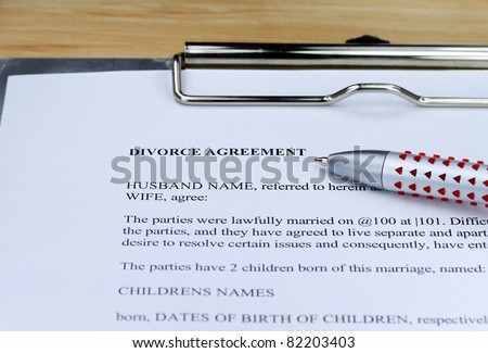 A Divorce contract on a lawyers desk along with a ball point pen for you to agree to.