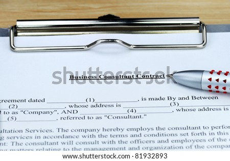 A Business Consultant form ready for you to sign, showing the form, ball point pen on a metal clipboard.