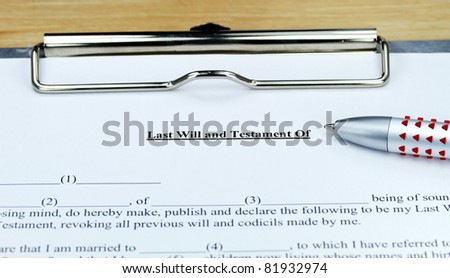 A last will and testament form ready for you to complete, showing the will, ball point pen on a metal clipboard.