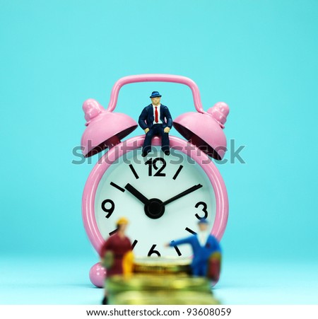 A couple walking up a golden coin stairway, with the bank manager ahead of them sat on a pastel pink alarm clock, asking the question, can you last the financial journey.